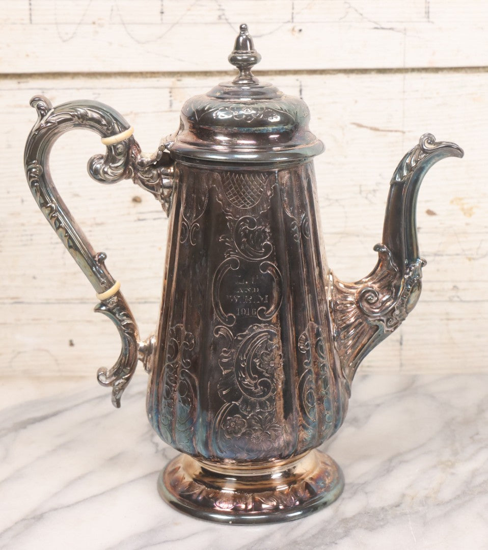 Lot 069 - Antique Embellished And Etched Silverplate Teapot With Hinged Lid And Handle With Bone Fittings, With Floral, Scroll And Pineapple Motifs, Engraved L.C. And W. R. M. 1916, 10-1/2" Height