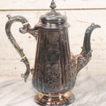 Lot 069 - Antique Embellished And Etched Silverplate Teapot With Hinged Lid And Handle With Bone Fittings, With Floral, Scroll And Pineapple Motifs, Engraved L.C. And W. R. M. 1916, 10-1/2" Height