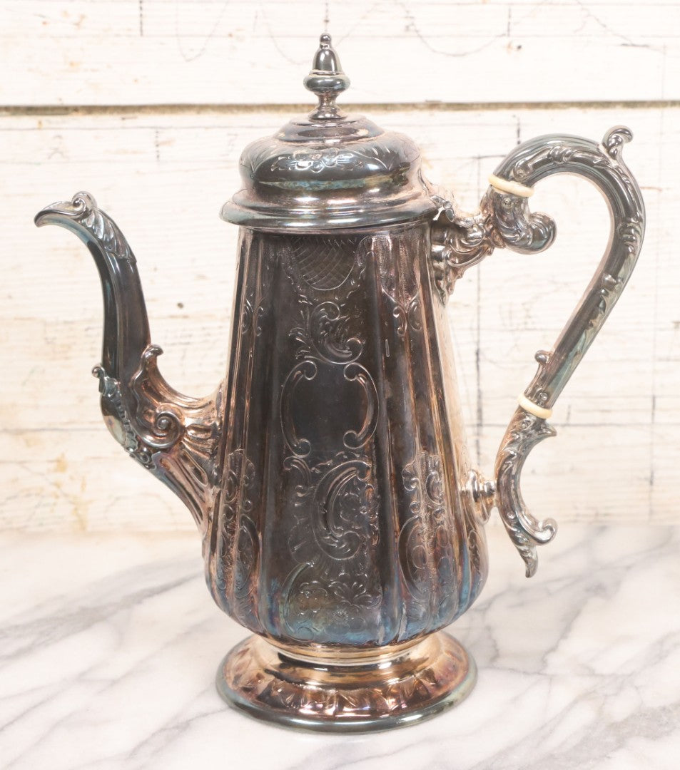 Lot 069 - Antique Embellished And Etched Silverplate Teapot With Hinged Lid And Handle With Bone Fittings, With Floral, Scroll And Pineapple Motifs, Engraved L.C. And W. R. M. 1916, 10-1/2" Height