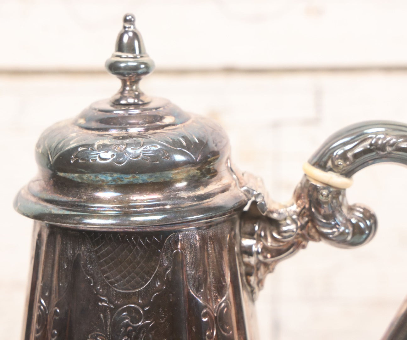 Lot 069 - Antique Embellished And Etched Silverplate Teapot With Hinged Lid And Handle With Bone Fittings, With Floral, Scroll And Pineapple Motifs, Engraved L.C. And W. R. M. 1916, 10-1/2" Height