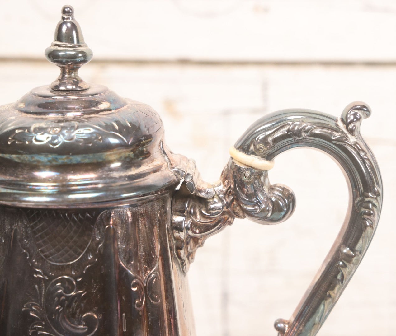 Lot 069 - Antique Embellished And Etched Silverplate Teapot With Hinged Lid And Handle With Bone Fittings, With Floral, Scroll And Pineapple Motifs, Engraved L.C. And W. R. M. 1916, 10-1/2" Height