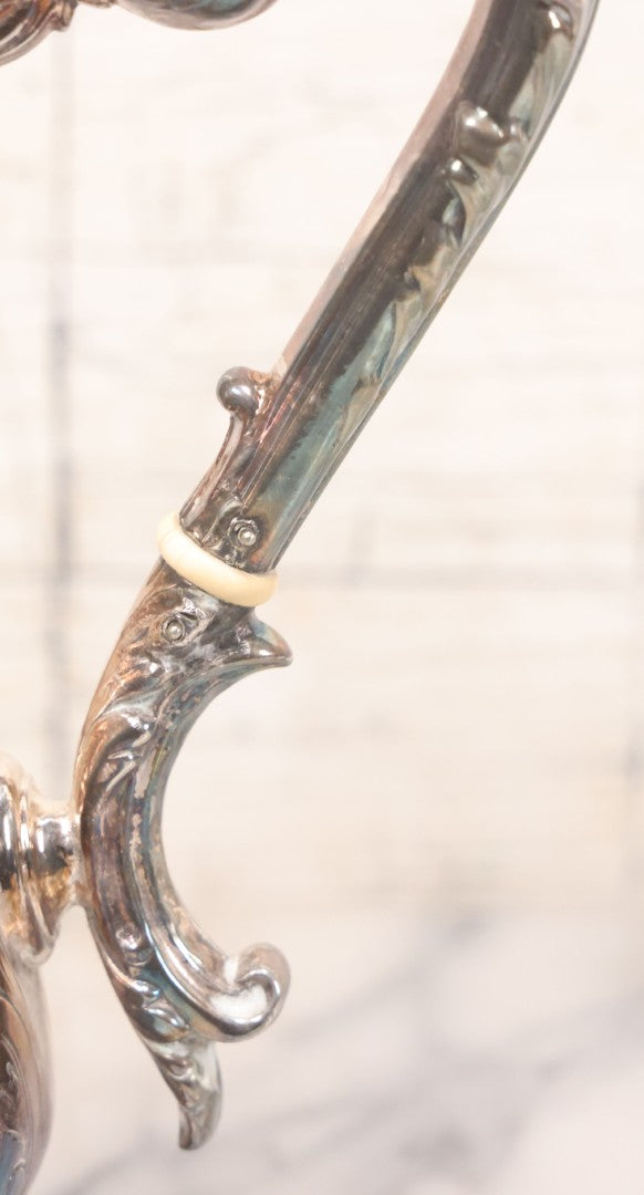 Lot 069 - Antique Embellished And Etched Silverplate Teapot With Hinged Lid And Handle With Bone Fittings, With Floral, Scroll And Pineapple Motifs, Engraved L.C. And W. R. M. 1916, 10-1/2" Height