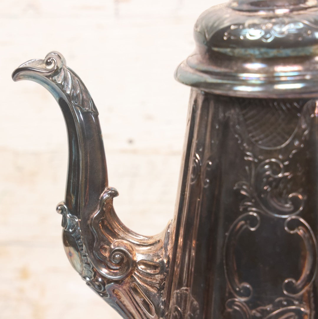 Lot 069 - Antique Embellished And Etched Silverplate Teapot With Hinged Lid And Handle With Bone Fittings, With Floral, Scroll And Pineapple Motifs, Engraved L.C. And W. R. M. 1916, 10-1/2" Height