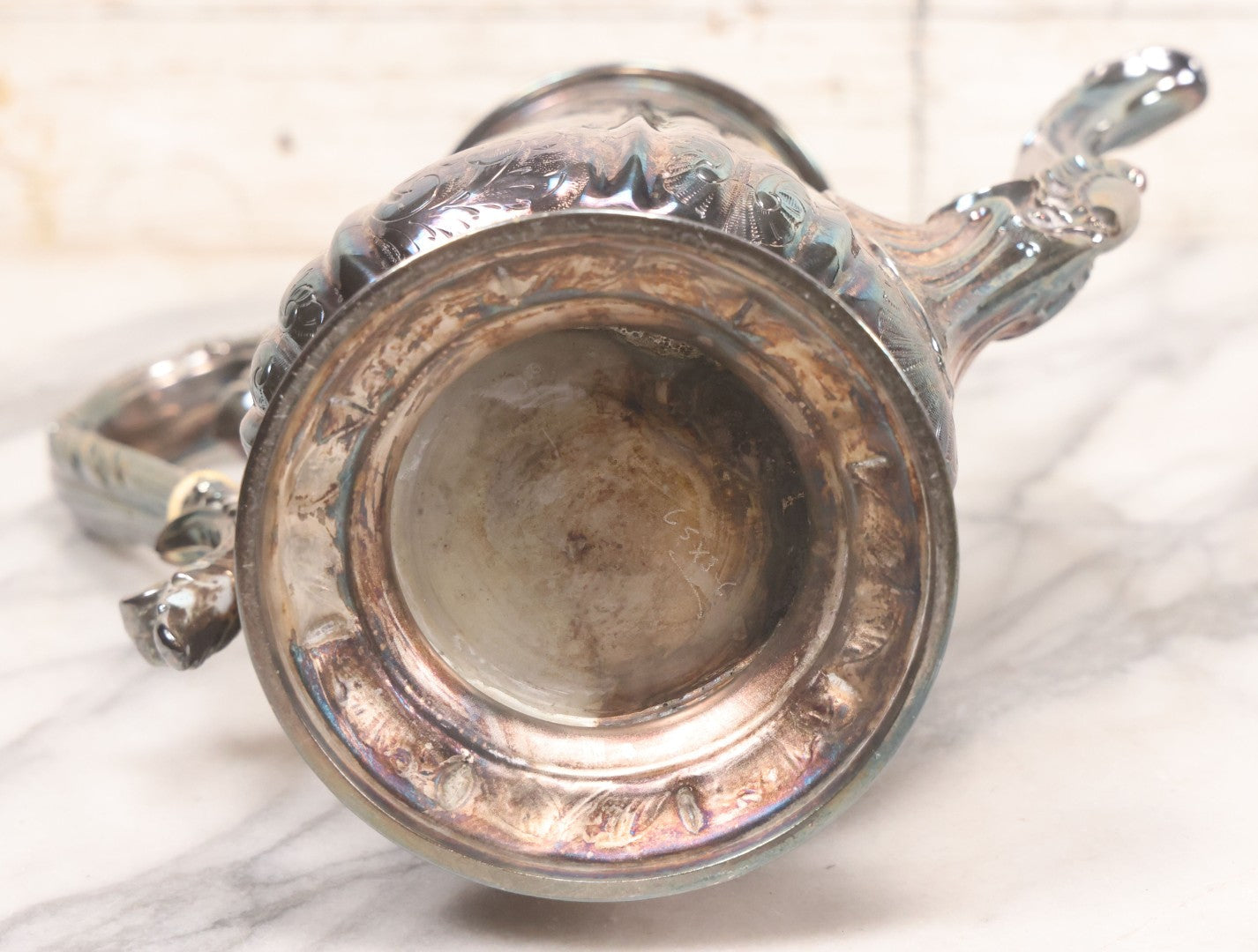 Lot 069 - Antique Embellished And Etched Silverplate Teapot With Hinged Lid And Handle With Bone Fittings, With Floral, Scroll And Pineapple Motifs, Engraved L.C. And W. R. M. 1916, 10-1/2" Height