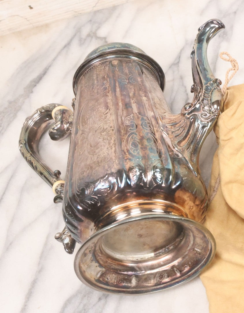 Lot 069 - Antique Embellished And Etched Silverplate Teapot With Hinged Lid And Handle With Bone Fittings, With Floral, Scroll And Pineapple Motifs, Engraved L.C. And W. R. M. 1916, 10-1/2" Height