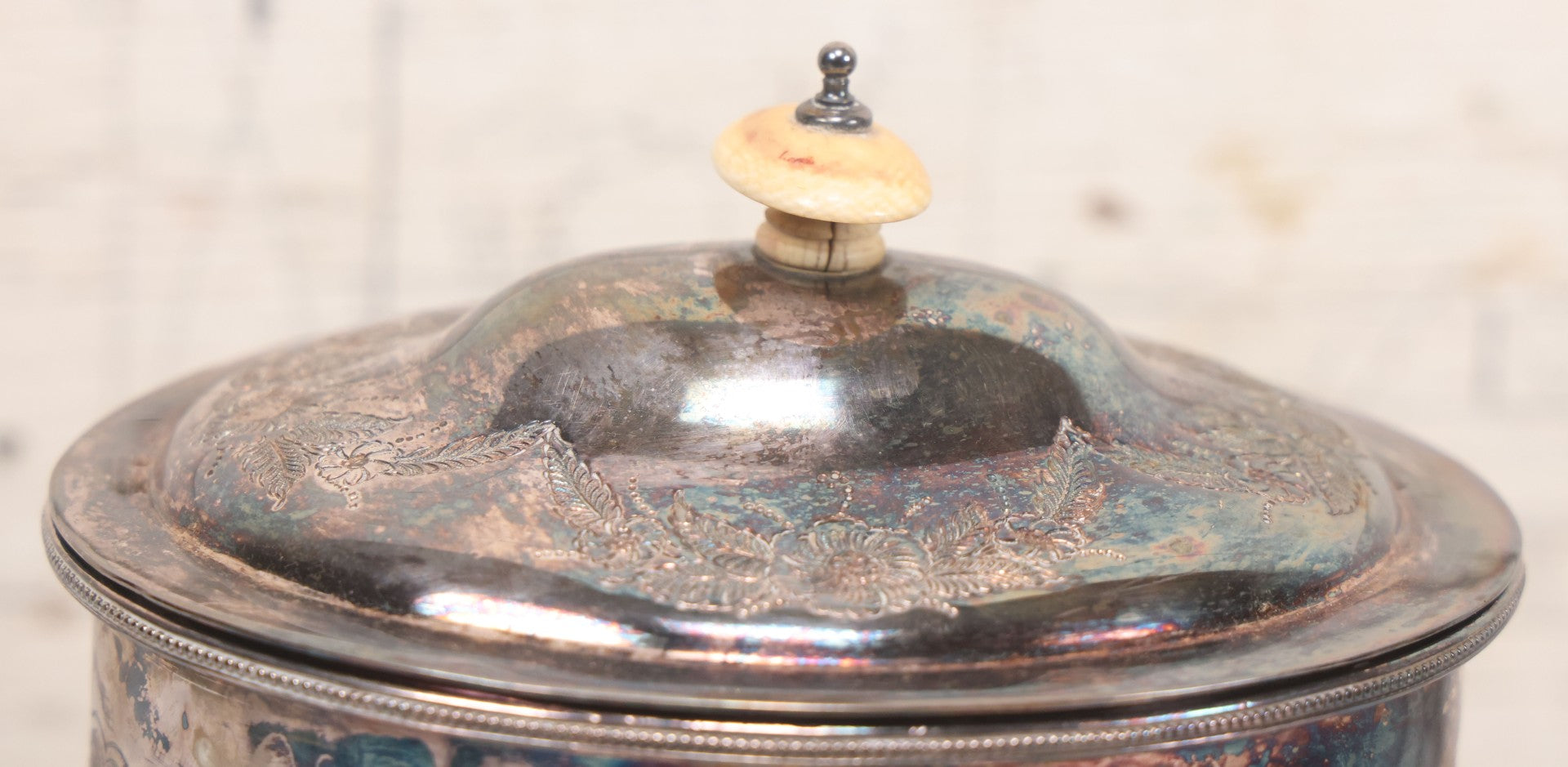 Lot 070 - Antique Etched Silverplate Single Piece Lidded Jar With Hinged Lid And Bone Handle On Slotted Tray With Feet, With Flower And Leaf Wreaths And Rope Twist Motifs, Marked J. E. & S. Ltd., Made In England, 7-1/2" Height