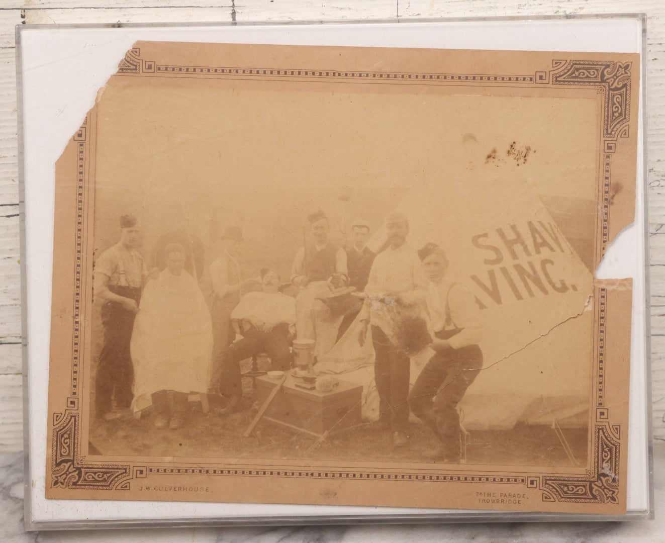 Lot 083 - Antique Boarded Photograph Of Soldier's Shaving Tent With Men Posing With Rifles, Barber, Implements And Tools, Photo By J.W. Culverhouse, " 7A The Parade, Trowbridge" Wiltshire, England, Note Photo Damaged, Losses