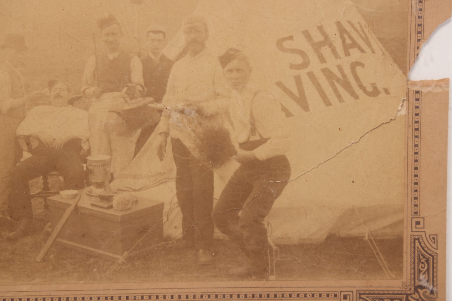 Lot 083 - Antique Boarded Photograph Of Soldier's Shaving Tent With Men Posing With Rifles, Barber, Implements And Tools, Photo By J.W. Culverhouse, " 7A The Parade, Trowbridge" Wiltshire, England, Note Photo Damaged, Losses