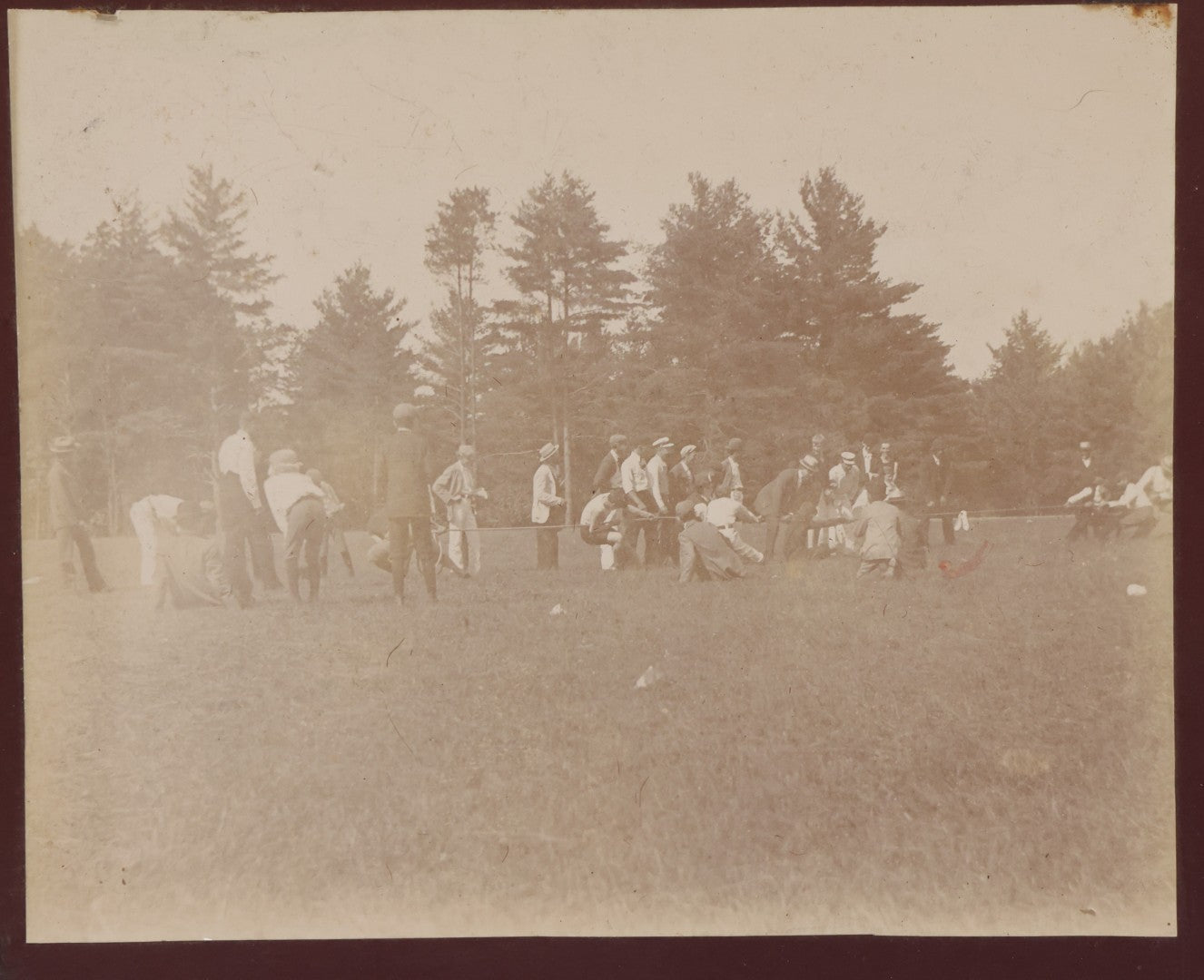 Lot 084 - Antique Boarded Photograph Of A Group Of Adults Engaged In A Tug-O-War Game In A Field