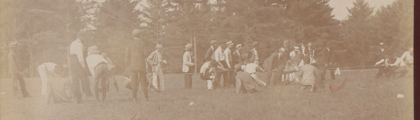 Lot 084 - Antique Boarded Photograph Of A Group Of Adults Engaged In A Tug-O-War Game In A Field