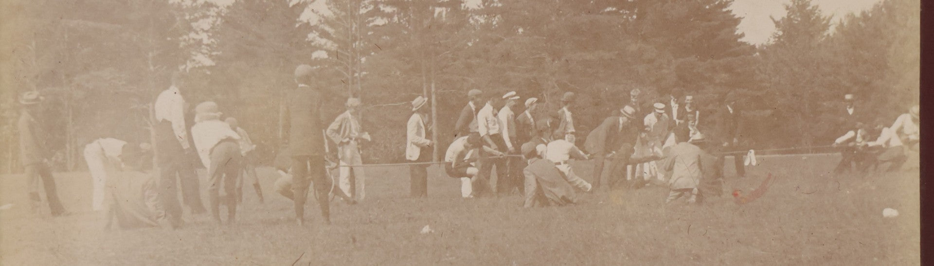 Lot 084 - Antique Boarded Photograph Of A Group Of Adults Engaged In A Tug-O-War Game In A Field