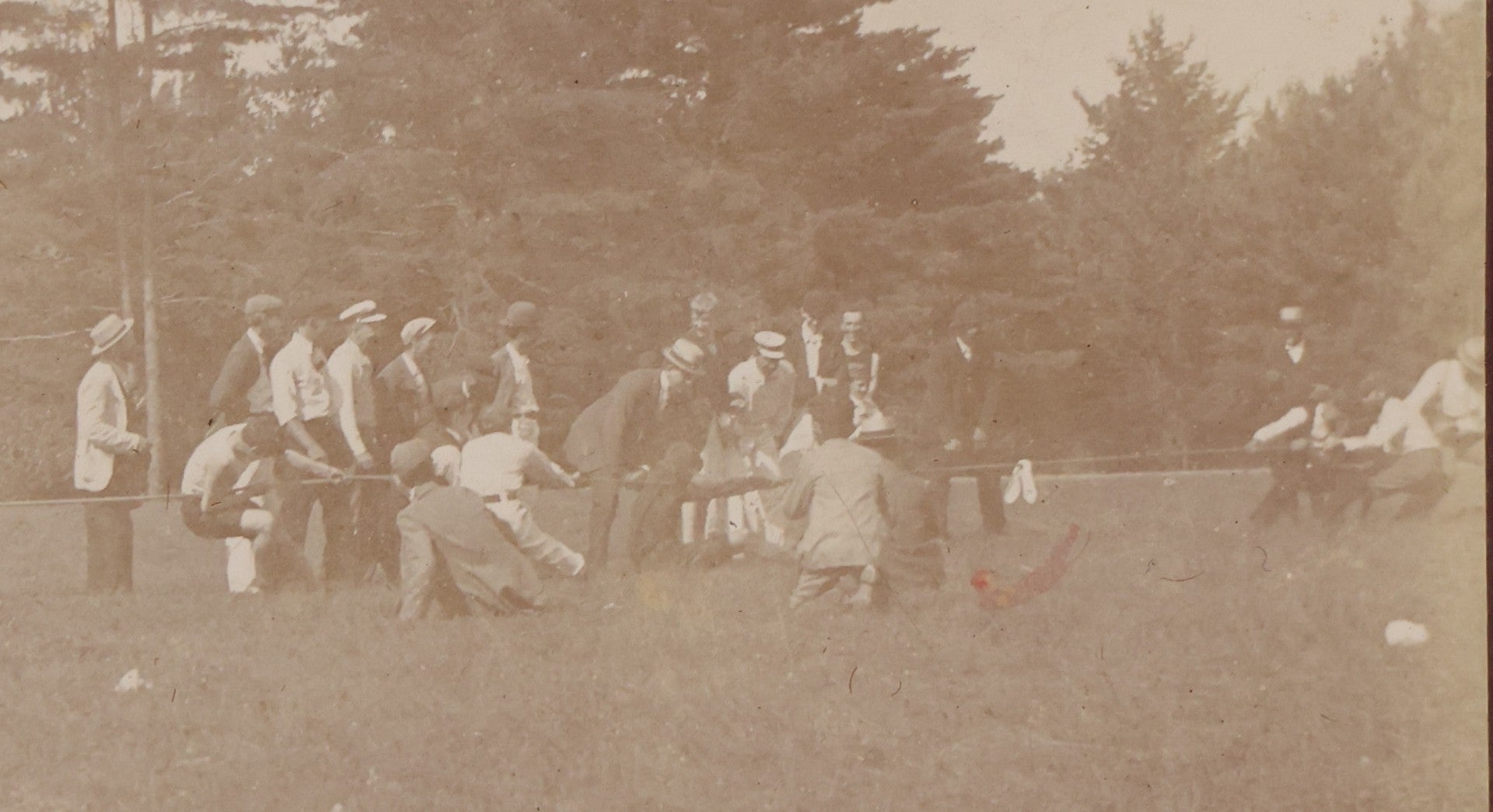 Lot 084 - Antique Boarded Photograph Of A Group Of Adults Engaged In A Tug-O-War Game In A Field