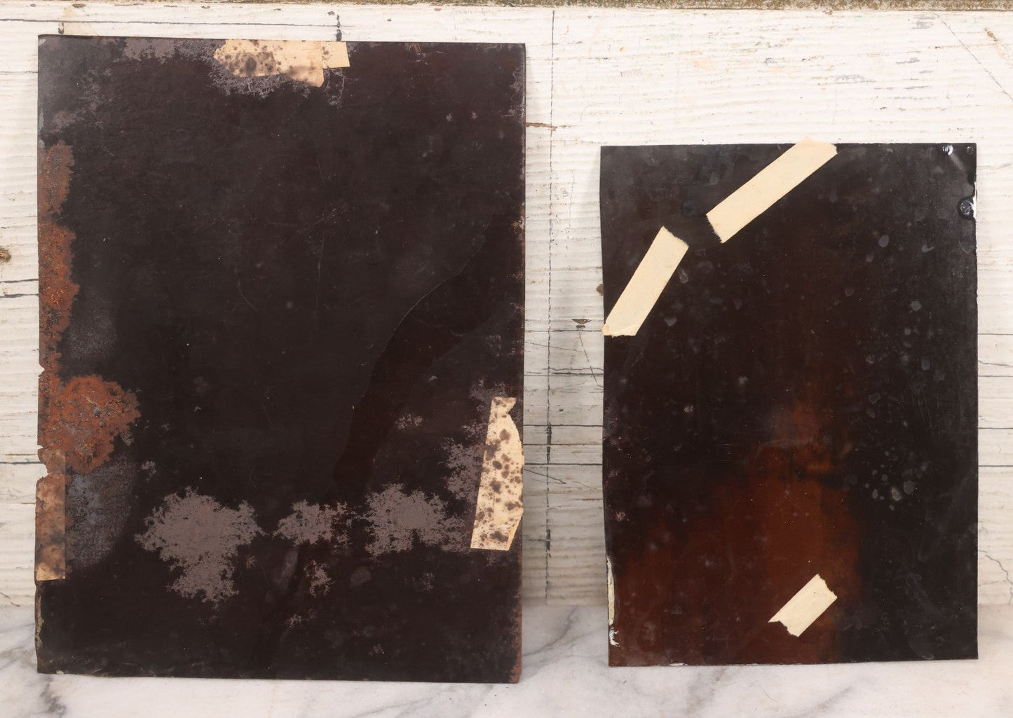 Lot 085 - Pair Of Antique Tintype Photographs Including Half Plate Tintype Of A Young Girl With Striped Socks And A Full Plate Tintype Of A Serious Looking Woman With Folded Hands