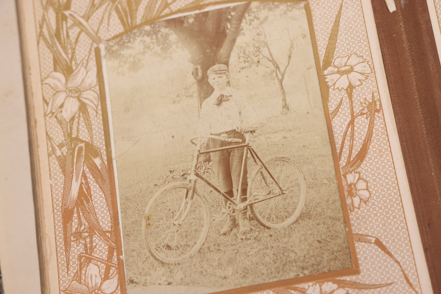 Lot 087 - Antique Cabinet Card Photo Album With Pressed Metal Cover, Floral Design, Raised Decorative Metal Album Lettering, Red Fabric Back Cover, Containing 58 Cabinet Card Photos Including Boy with Bicycle, Knights Templar, and Woman in Mourning