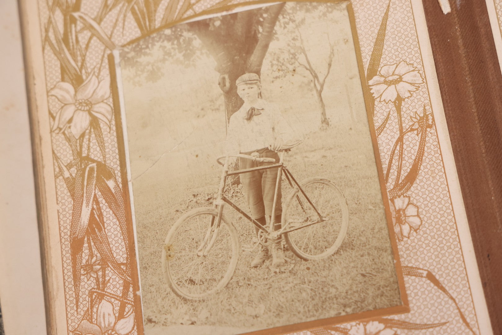 Lot 087 - Antique Cabinet Card Photo Album With Pressed Metal Cover, Floral Design, Raised Decorative Metal Album Lettering, Red Fabric Back Cover, Containing 58 Cabinet Card Photos Including Boy with Bicycle, Knights Templar, and Woman in Mourning