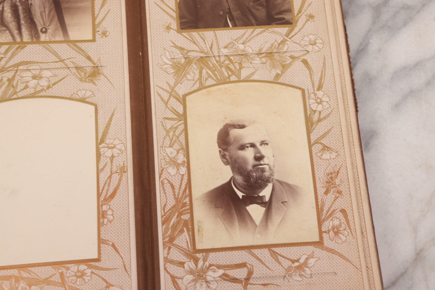 Lot 087 - Antique Cabinet Card Photo Album With Pressed Metal Cover, Floral Design, Raised Decorative Metal Album Lettering, Red Fabric Back Cover, Containing 58 Cabinet Card Photos Including Boy with Bicycle, Knights Templar, and Woman in Mourning