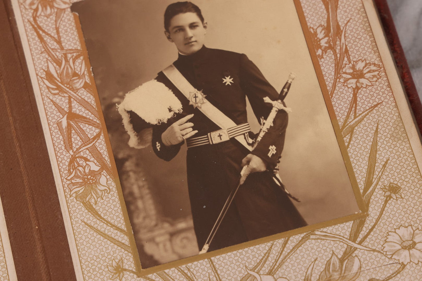 Lot 087 - Antique Cabinet Card Photo Album With Pressed Metal Cover, Floral Design, Raised Decorative Metal Album Lettering, Red Fabric Back Cover, Containing 58 Cabinet Card Photos Including Boy with Bicycle, Knights Templar, and Woman in Mourning