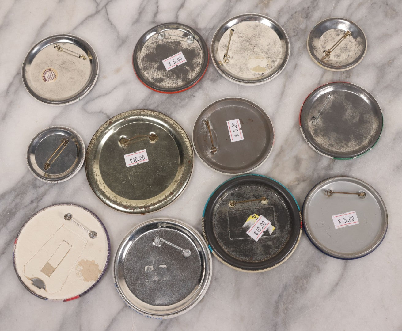 Lot 094 - Vintage Grouping Of 12 Buttons, Including Signed Jerry Hopp Button, "Super Salami" Racing Buttons, Vote For Kermit Button, Others