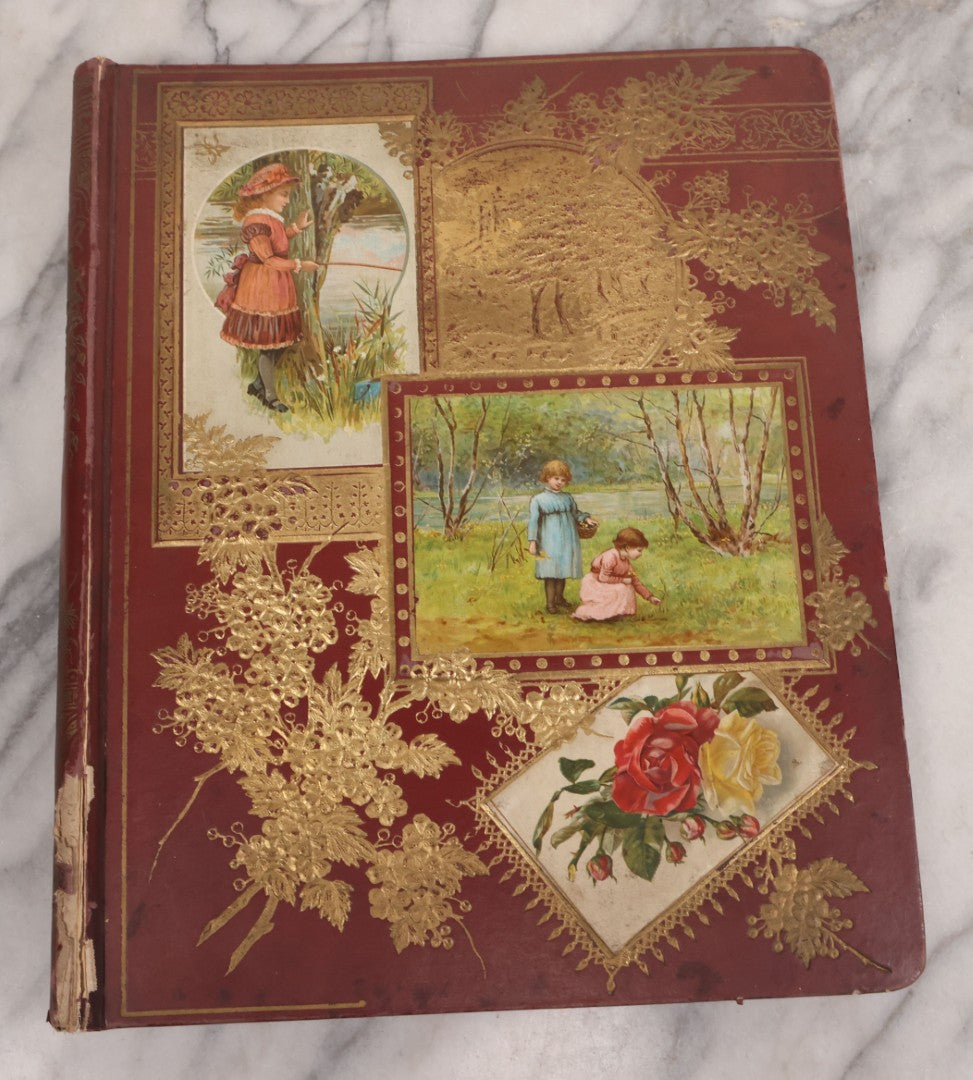 Lot 115 - Antique Victorian Scrapbook Album With Children, Flowers, Foliage On Cover Containing 50+ Pieces Including Trade Cards, Die Cuts, Calling Cards, And Other Scraps