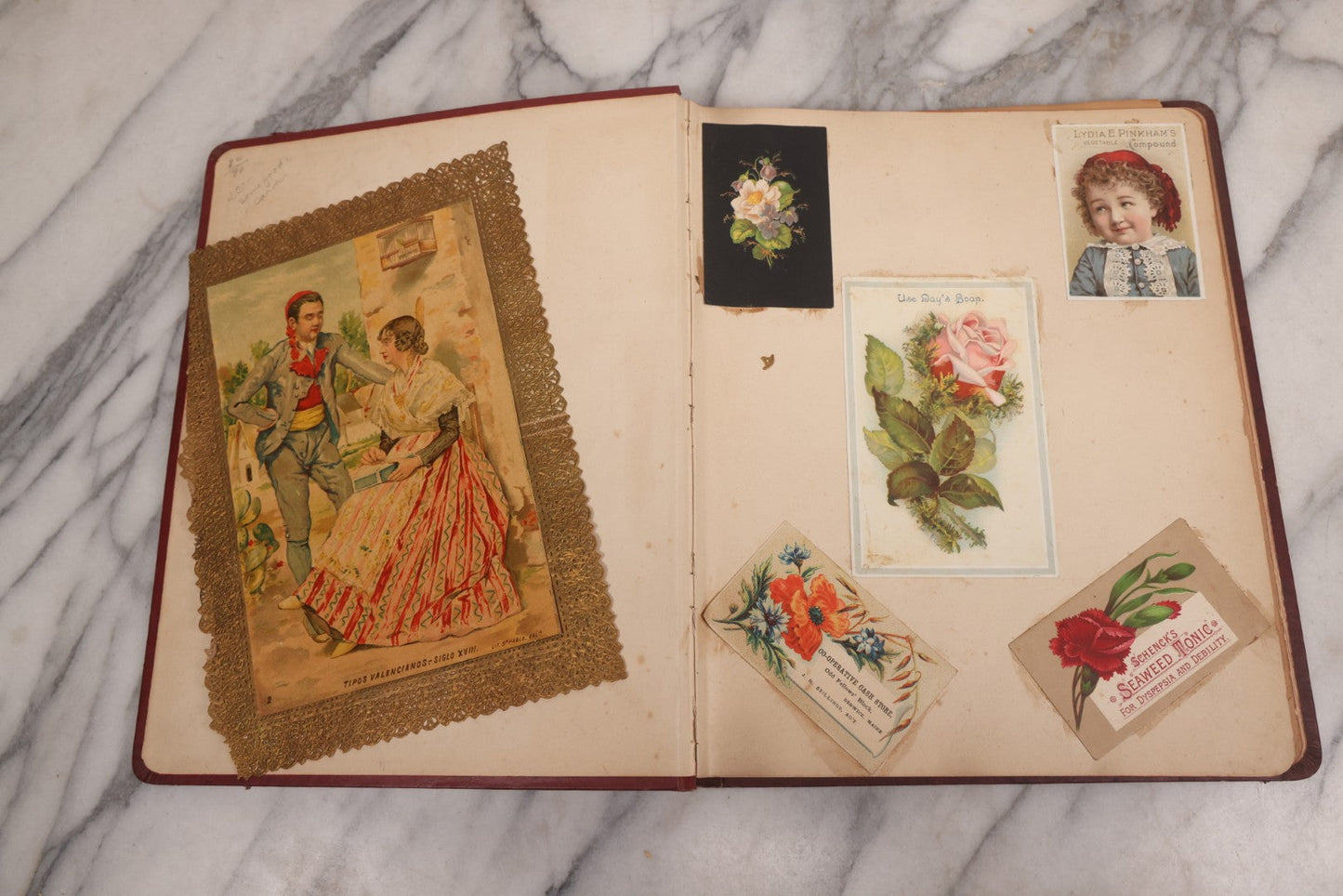 Lot 115 - Antique Victorian Scrapbook Album With Children, Flowers, Foliage On Cover Containing 50+ Pieces Including Trade Cards, Die Cuts, Calling Cards, And Other Scraps