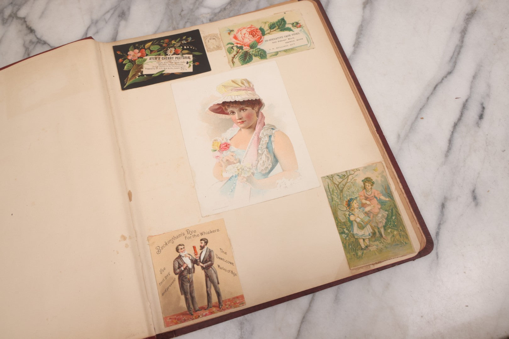 Lot 115 - Antique Victorian Scrapbook Album With Children, Flowers, Foliage On Cover Containing 50+ Pieces Including Trade Cards, Die Cuts, Calling Cards, And Other Scraps
