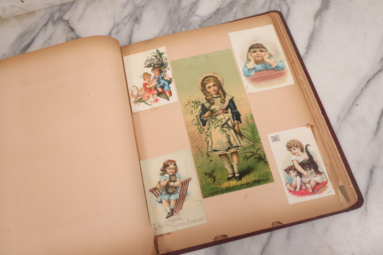 Lot 115 - Antique Victorian Scrapbook Album With Children, Flowers, Foliage On Cover Containing 50+ Pieces Including Trade Cards, Die Cuts, Calling Cards, And Other Scraps