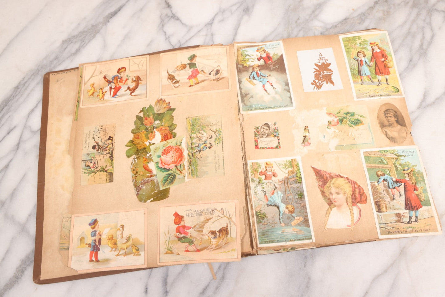 Lot 116 - Antique Victorian Scrapbook Album With Cat, Other Designs On Cover Containing 100+ Pieces Including Trade Cards, Die Cuts, Calling Cards, And Other Scraps