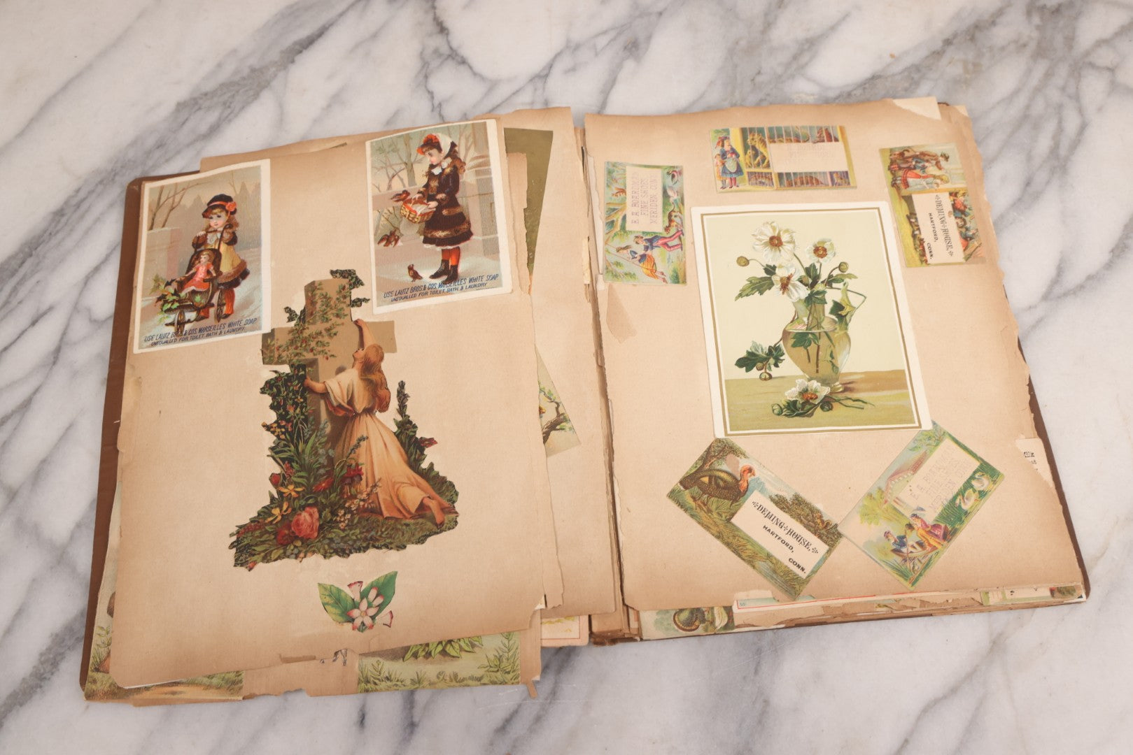 Lot 116 - Antique Victorian Scrapbook Album With Cat, Other Designs On Cover Containing 100+ Pieces Including Trade Cards, Die Cuts, Calling Cards, And Other Scraps