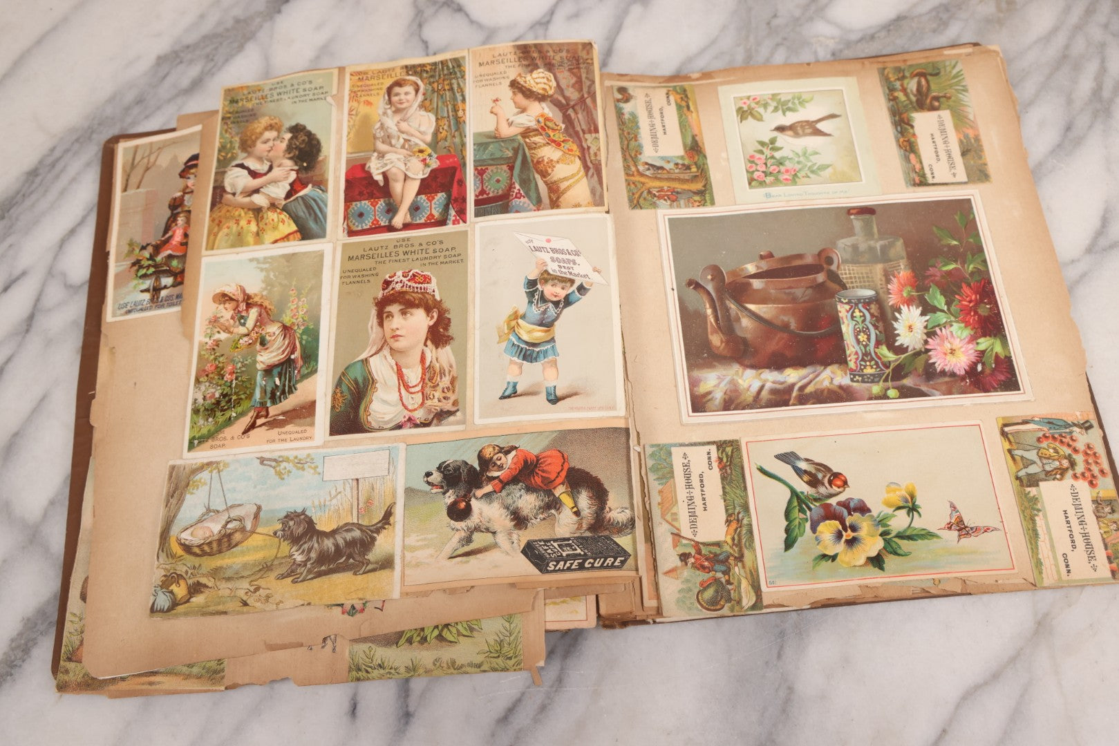 Lot 116 - Antique Victorian Scrapbook Album With Cat, Other Designs On Cover Containing 100+ Pieces Including Trade Cards, Die Cuts, Calling Cards, And Other Scraps