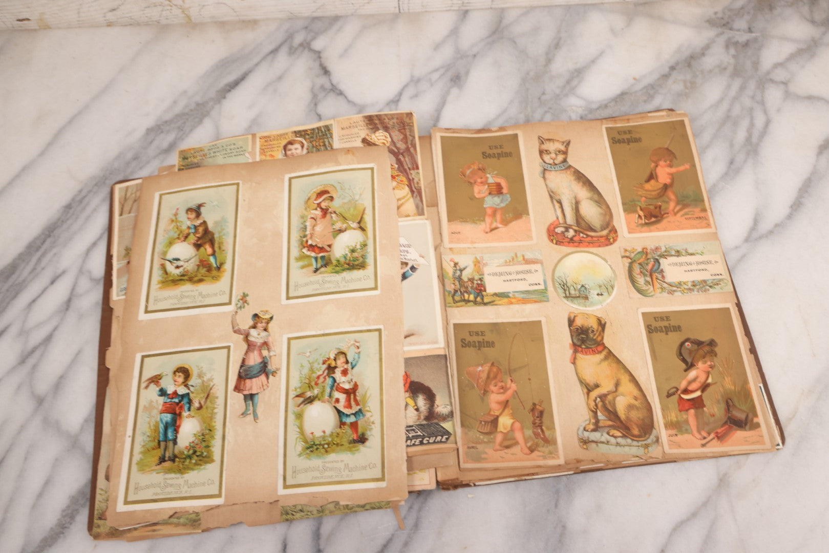 Lot 116 - Antique Victorian Scrapbook Album With Cat, Other Designs On Cover Containing 100+ Pieces Including Trade Cards, Die Cuts, Calling Cards, And Other Scraps