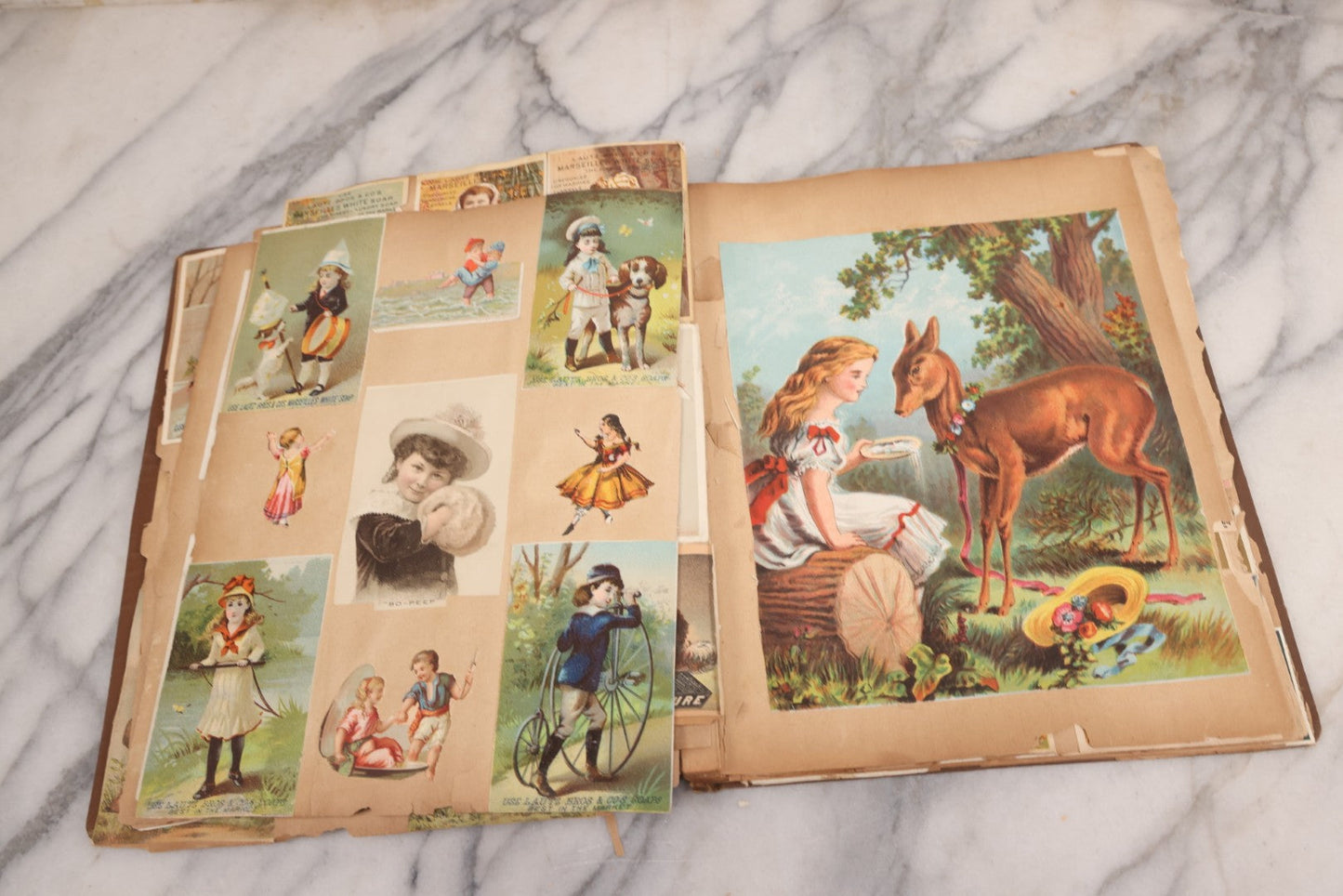 Lot 116 - Antique Victorian Scrapbook Album With Cat, Other Designs On Cover Containing 100+ Pieces Including Trade Cards, Die Cuts, Calling Cards, And Other Scraps