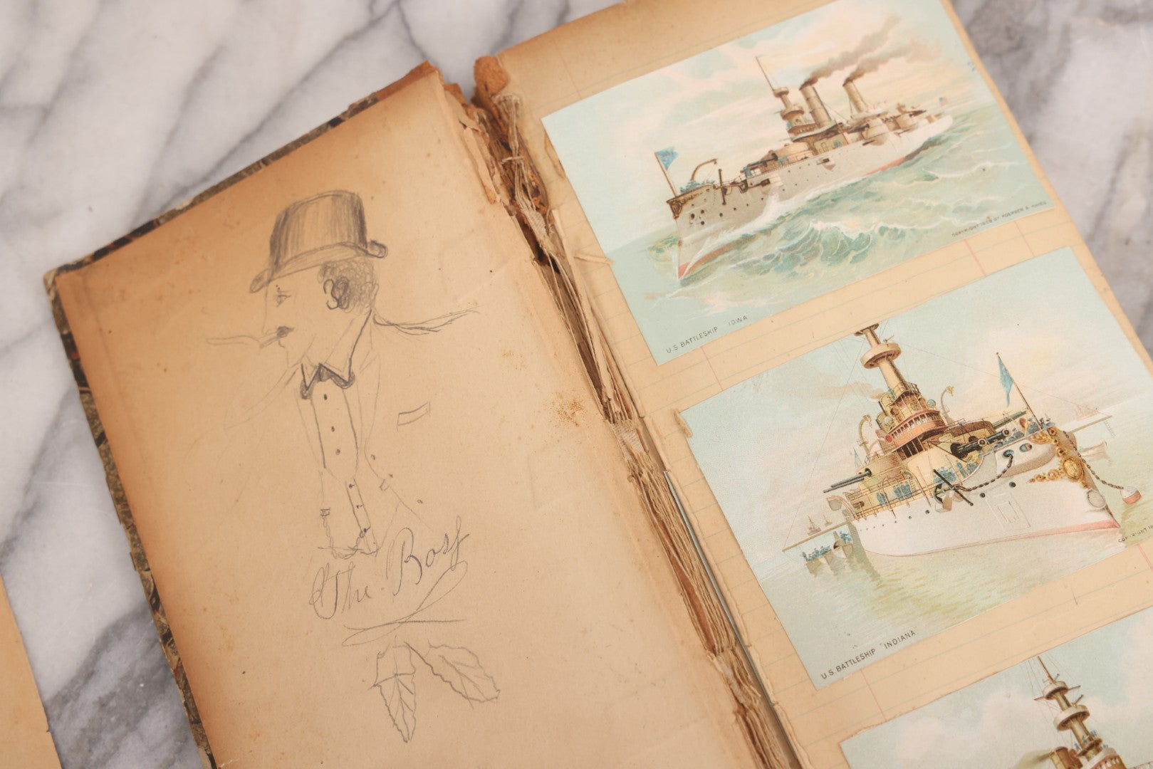 Lot 118 - Antique Scrapbook Album Made From An Old Cash Book Ledger Containing 15 Lithographed Card Featuring United States Battleships Of The Spanish American War Era, Cards Copyright 1898 By Koerner & Hayes, With Four Additional Cards, Doodles, Etc.