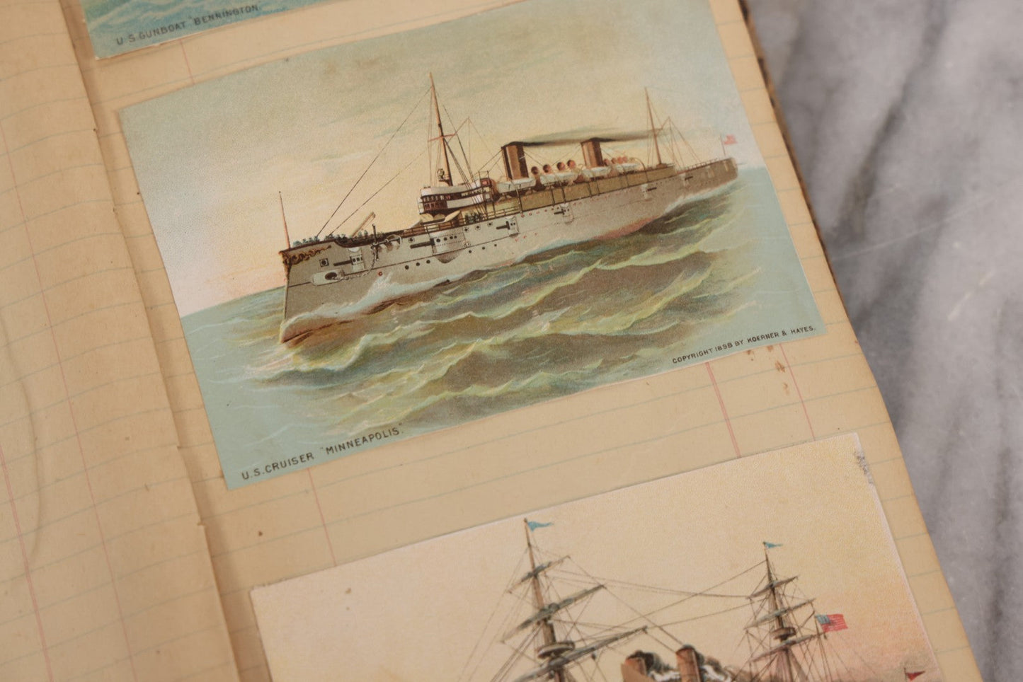 Lot 118 - Antique Scrapbook Album Made From An Old Cash Book Ledger Containing 15 Lithographed Card Featuring United States Battleships Of The Spanish American War Era, Cards Copyright 1898 By Koerner & Hayes, With Four Additional Cards, Doodles, Etc.