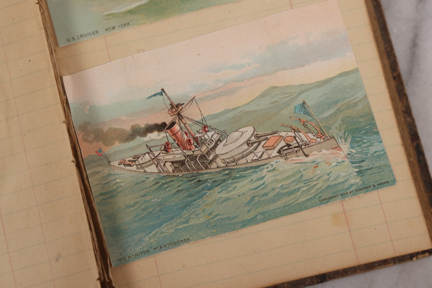 Lot 118 - Antique Scrapbook Album Made From An Old Cash Book Ledger Containing 15 Lithographed Card Featuring United States Battleships Of The Spanish American War Era, Cards Copyright 1898 By Koerner & Hayes, With Four Additional Cards, Doodles, Etc.