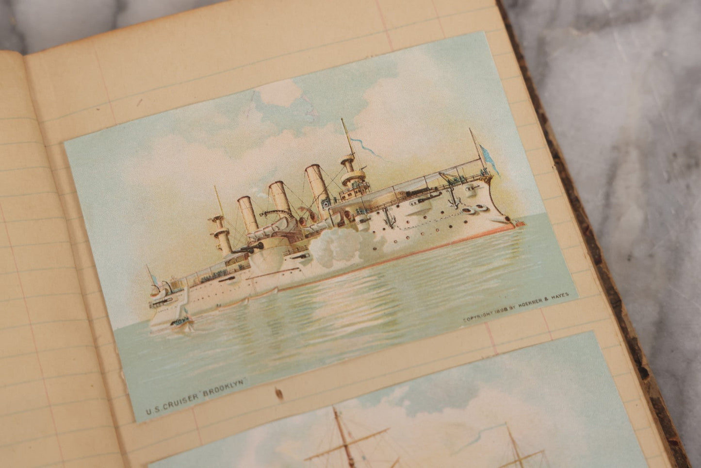 Lot 118 - Antique Scrapbook Album Made From An Old Cash Book Ledger Containing 15 Lithographed Card Featuring United States Battleships Of The Spanish American War Era, Cards Copyright 1898 By Koerner & Hayes, With Four Additional Cards, Doodles, Etc.