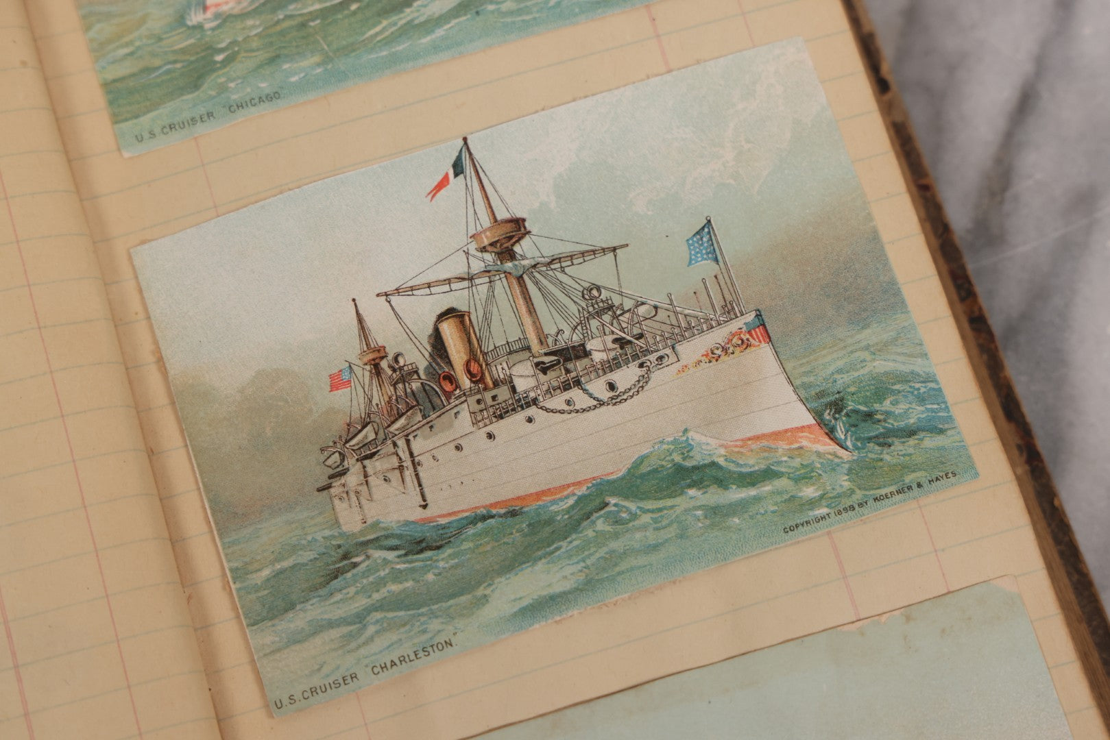 Lot 118 - Antique Scrapbook Album Made From An Old Cash Book Ledger Containing 15 Lithographed Card Featuring United States Battleships Of The Spanish American War Era, Cards Copyright 1898 By Koerner & Hayes, With Four Additional Cards, Doodles, Etc.