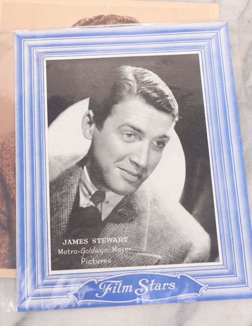 Lot 128 - Grouping Of Eight Large Format Photo Prints, Movie Stars And Metro-Goldwyn-Mayer Pictures Film Stars Series, Including Katharine Hepburn (1907-2003) Rko Radio Star, Shirley Temple (1928-2014), And James Stewart (1908-1997)