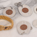 Lot 152 - Vintage Grouping Of Four  Souvenir Coin Dogtags, "Keep Me And Never Go Broke" Penny Souvenir, Shell's Coin Game Souvenir Coin, And Heart Locket Expanding Bracelet