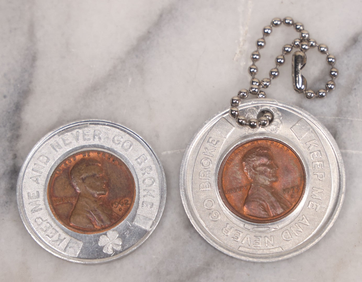 Lot 152 - Vintage Grouping Of Four  Souvenir Coin Dogtags, "Keep Me And Never Go Broke" Penny Souvenir, Shell's Coin Game Souvenir Coin, And Heart Locket Expanding Bracelet