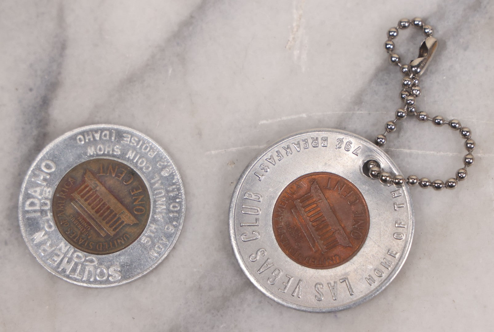 Lot 152 - Vintage Grouping Of Four  Souvenir Coin Dogtags, "Keep Me And Never Go Broke" Penny Souvenir, Shell's Coin Game Souvenir Coin, And Heart Locket Expanding Bracelet