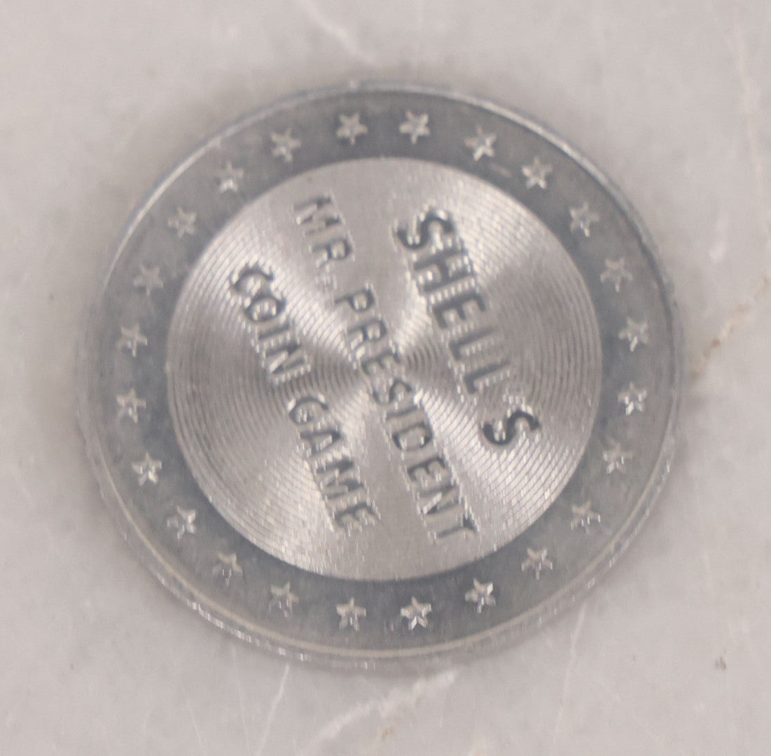 Lot 152 - Vintage Grouping Of Four  Souvenir Coin Dogtags, "Keep Me And Never Go Broke" Penny Souvenir, Shell's Coin Game Souvenir Coin, And Heart Locket Expanding Bracelet