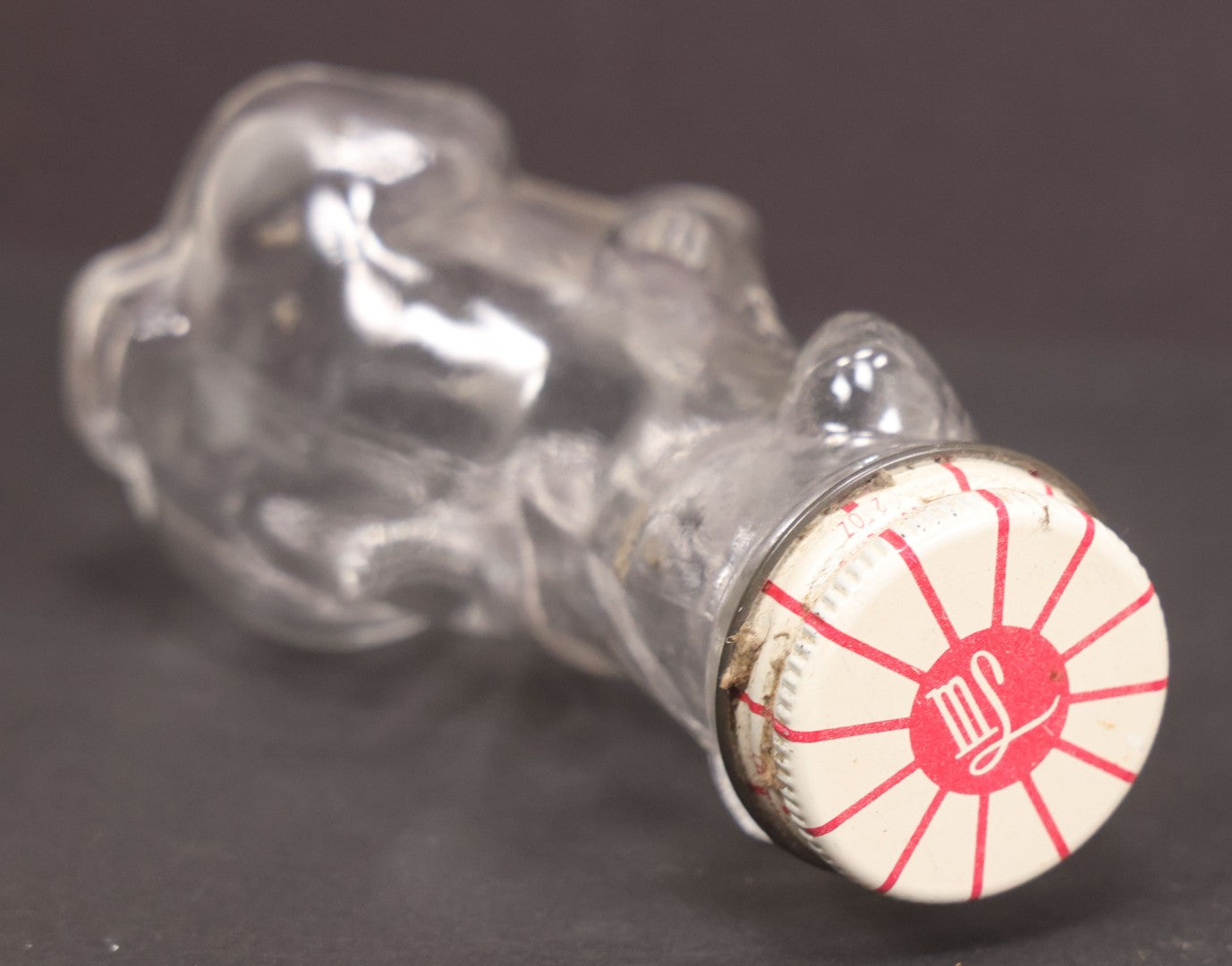 Lot 161 - Vintage Clear Glass Scottie Dog Candy Container With Original White And Red Metal "M.L." Twist Cap, 3-5/8" Height