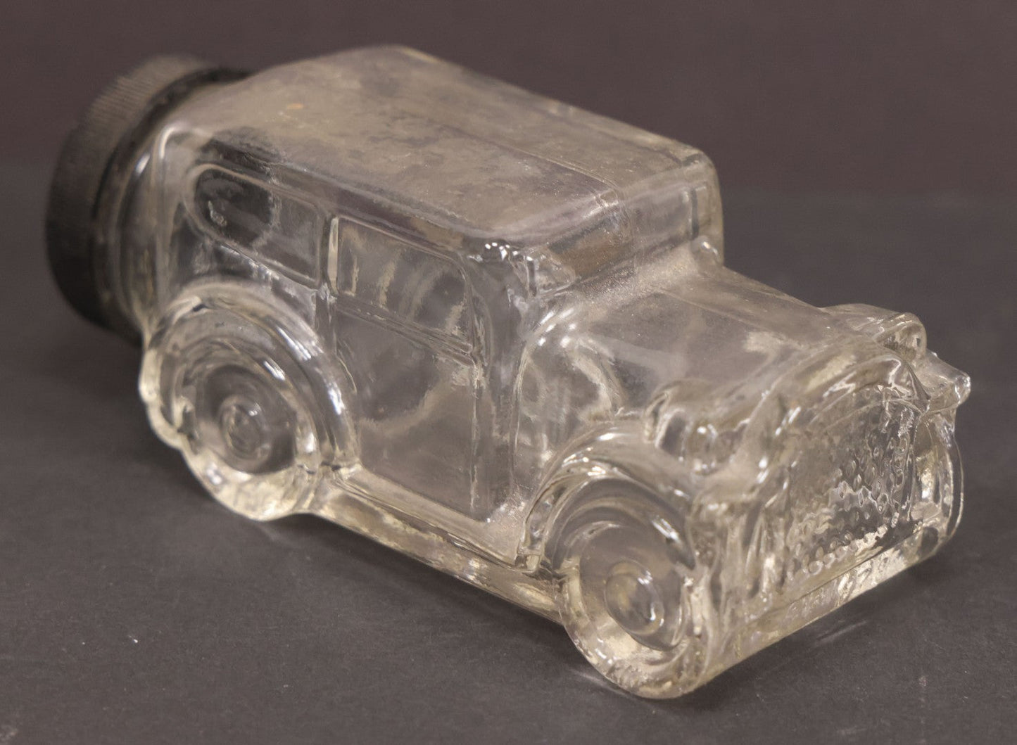 Lot 162 - Vintage Clear Glass Automobile Candy Container With Black Plastic Twist Cap, 4-3/4" Length