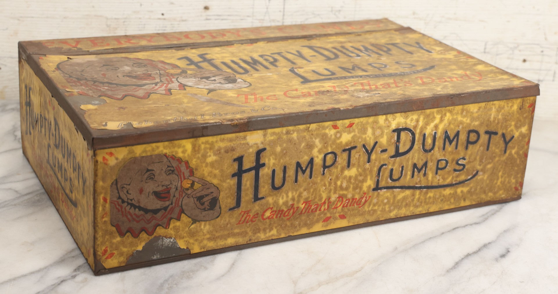 Lot 011 - Vintage Humpty-Dumpty Lumps, Cocoanut-Coated Candy Advertising Store Display Tin With Paper Labels, Clown Motif, "Everybody's Candy - The Candy That's Dandy," Liebenthal Bros. & Co., Note Severe Wear, Losses, Staining To Labels