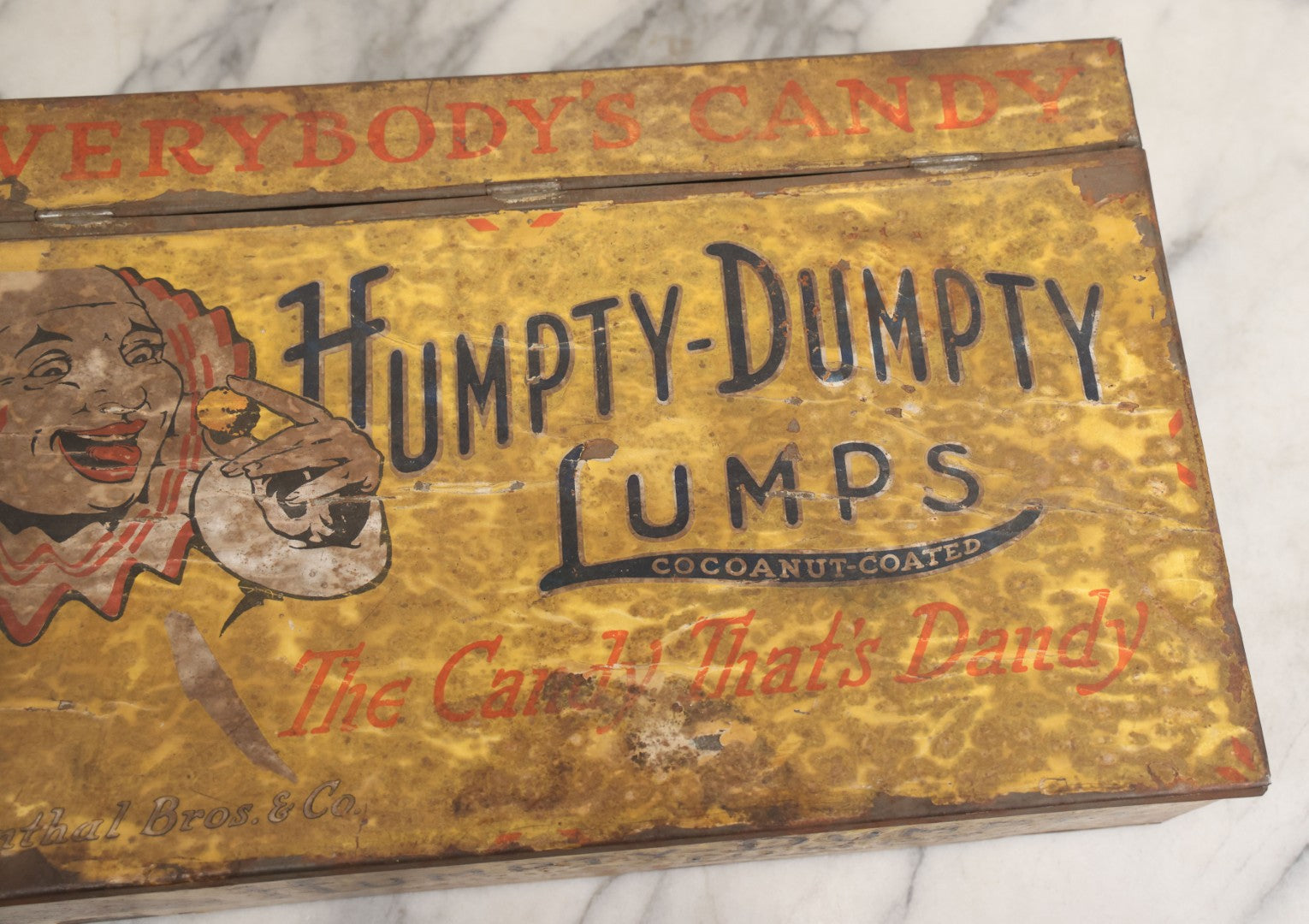 Lot 011 - Vintage Humpty-Dumpty Lumps, Cocoanut-Coated Candy Advertising Store Display Tin With Paper Labels, Clown Motif, "Everybody's Candy - The Candy That's Dandy," Liebenthal Bros. & Co., Note Severe Wear, Losses, Staining To Labels