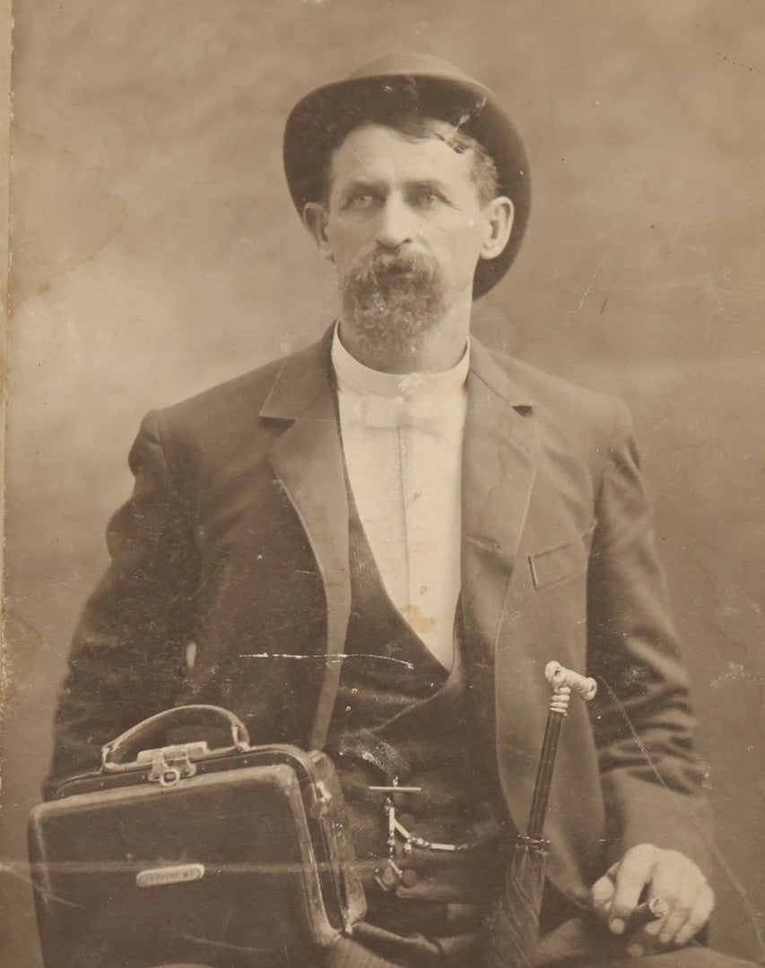 Lot 027 - Pair Of Antique Boarded Photographs Of Dr. Julius Benson Evans In Life And Death, Including Occupational Photo Of Doctor With Bag, And Post Mortem Photo Of Deceased Doctor Lying At Rest