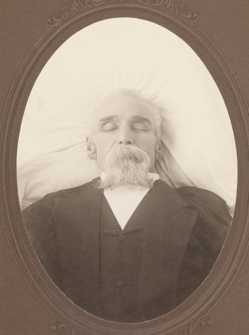 Lot 027 - Pair Of Antique Boarded Photographs Of Dr. Julius Benson Evans In Life And Death, Including Occupational Photo Of Doctor With Bag, And Post Mortem Photo Of Deceased Doctor Lying At Rest