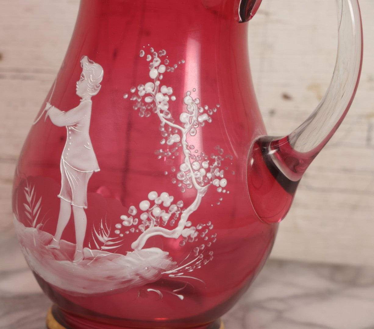 Lot 042 -  Antique Mary Gregory Style Cranberry Glass Pitcher Hand Painted Enamel Decoration Of Boy Playing Hoop And Gold Trim