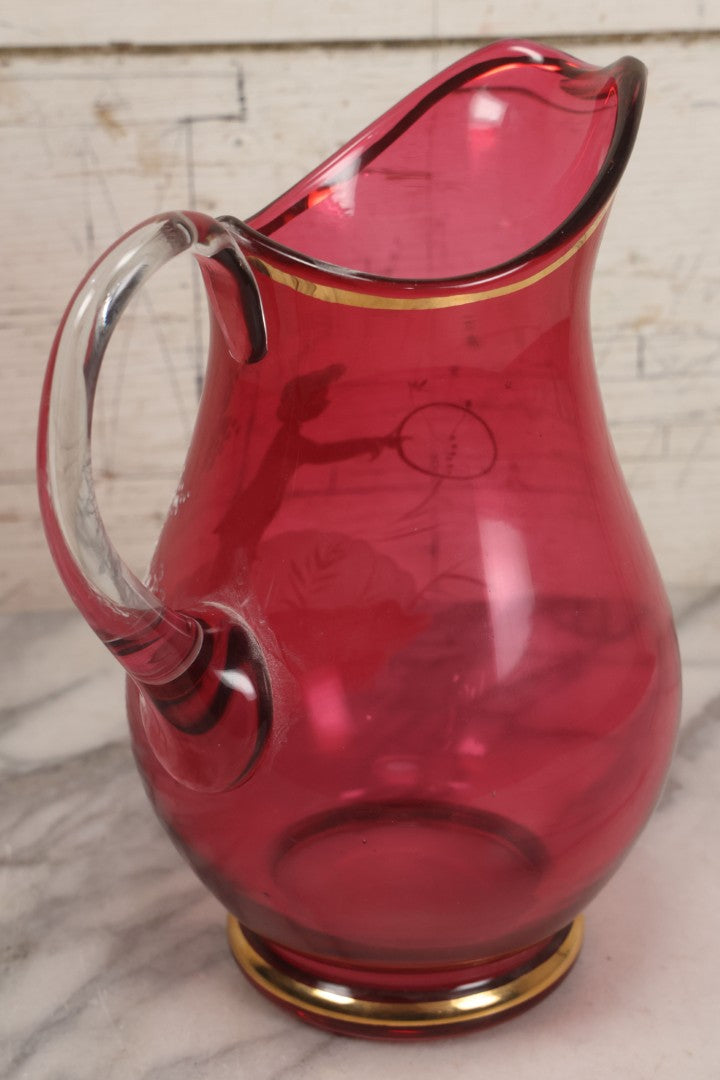 Lot 042 -  Antique Mary Gregory Style Cranberry Glass Pitcher Hand Painted Enamel Decoration Of Boy Playing Hoop And Gold Trim