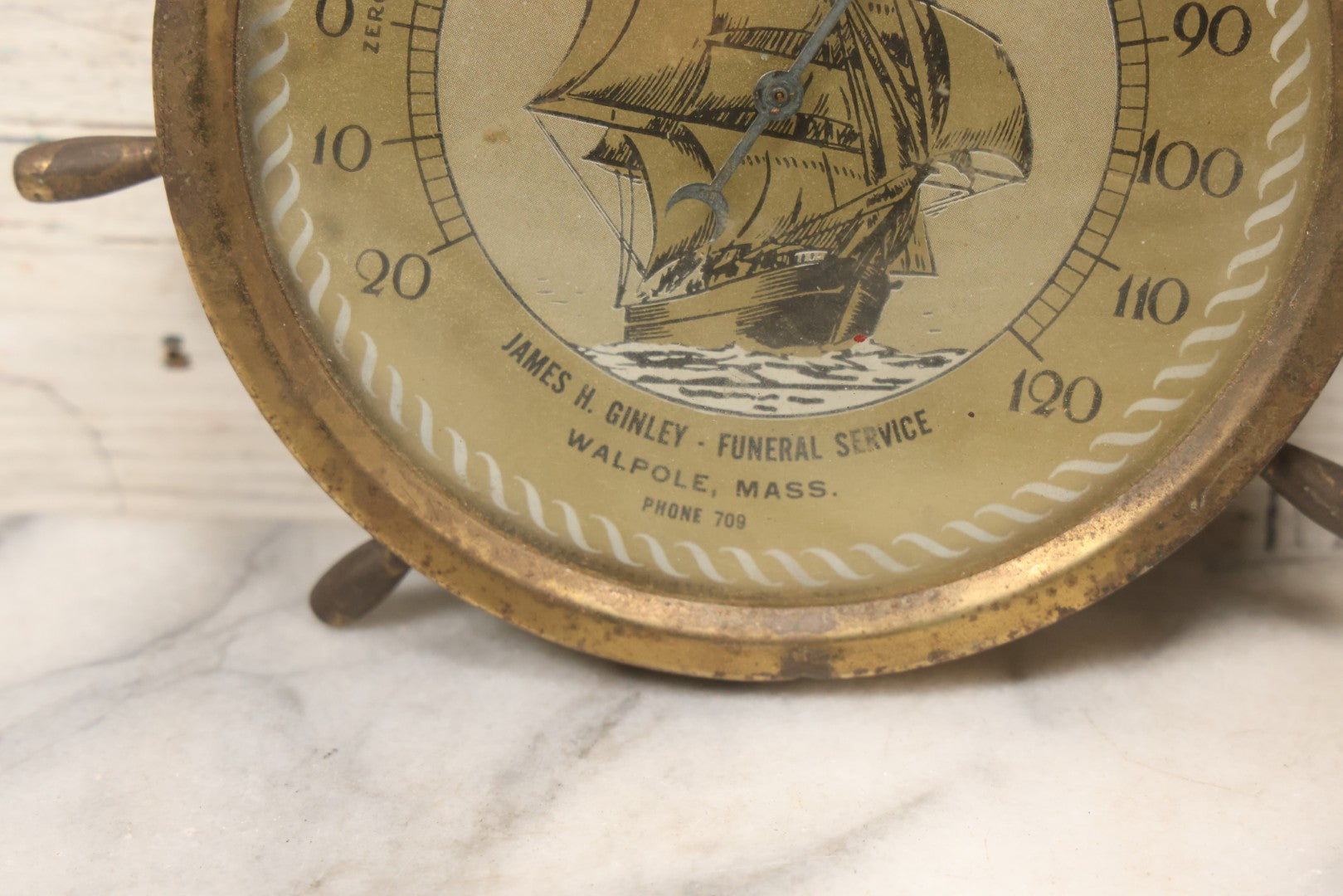 Lot 045 - Vintage Brass Advertising Thermometer With Nautical Motifs, Ship Wheel, Advertising James H. Ginley, Funeral Service, Walpole, Massachusetts